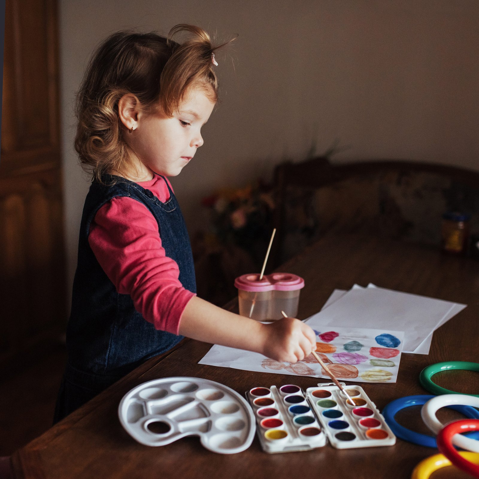 cute little girl draws a circle of colored paints cute little girl draws a circle of colored paints
